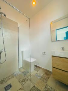 a bathroom with a shower and a toilet and a sink at Las Cuevas - 3 bed finca in a serene setting in Santa Cruz de Tenerife