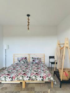 a bedroom with a large bed with a floral bedspread at Las Cuevas - 3 bed finca in a serene setting in Santa Cruz de Tenerife +25 photos