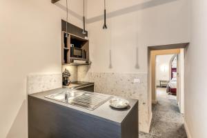 a kitchen with a sink and a counter top at Palazzo Ottavia - La Maison D'art Collection in Rome +49 photos