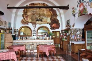 a restaurant with a bar with tables and chairs at Hotel La Certosa in Massa Lubrense +26 photos
