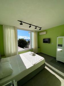 a bedroom with a bed and a large window at Sıla pansiyon in Gümbet