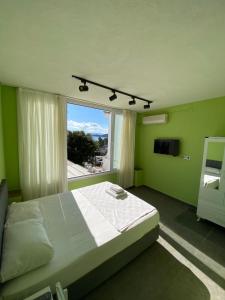 a bedroom with a bed and a large window at Sıla pansiyon in Gümbet