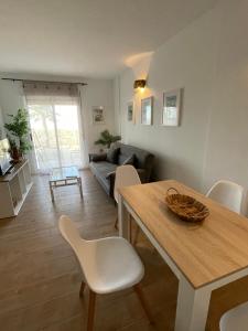 a living room with a table and chairs and a couch at Casa Cabo Palos in Cabo de Palos