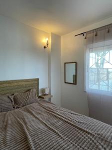 a bedroom with a large bed and a window at Casa Cabo Palos in Cabo de Palos +50 photos