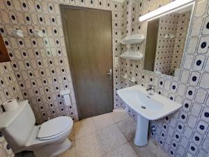a bathroom with a toilet and a sink at Hostal Playa in Cala Santanyi