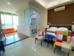 a bedroom with a bed and a table and chairs at Ashore 196 B&B in Dongshan
