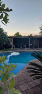 a swimming pool with a picnic table in the background at Haley's cabin in Tauranga