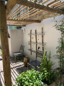 a patio with two chairs and a wooden pergola at Mia Amore in Caledon