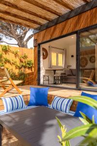 an outdoor patio with blue pillows and a table at Toison D'or in Saint-Tropez