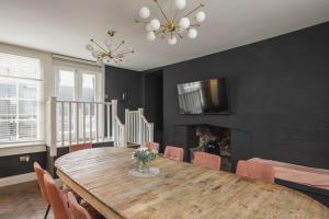 a dining room with a wooden table and chairs at Luxury Home with Terrace in Central Bath Sleeps 10 in Bath