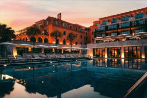 a hotel with a pool in front of a building at Grande Real Villa Itália Hotel & Spa in Cascais