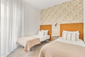 Posteľ alebo postele v izbe v ubytovaní Epidemia & quite bedrooms by ELE Apartments