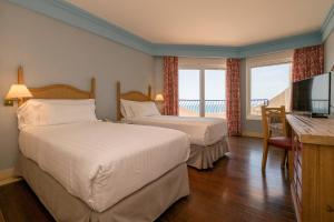 Кровать или кровати в номере Hotel Playa Victoria