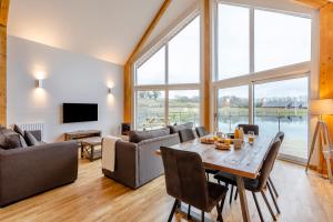 a large living room with a table and chairs at Landal Twin Lakes in Carnforth