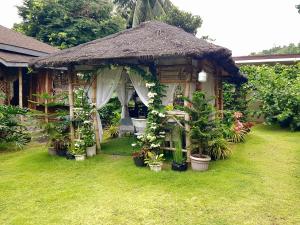 a house with a gazebo with plants in it at Hidden Haven Coron in Coron