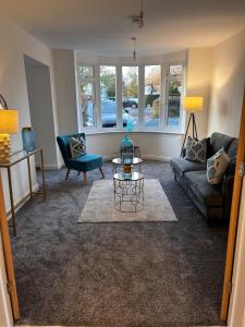 a living room with a couch and a table at Beautiful, luxury house! in Higham on the Hill