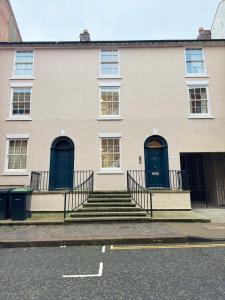 a building with blue doors and stairs in front at Osbourne House - BLUE 2 Bedroom,2 and half bath in Birmingham
