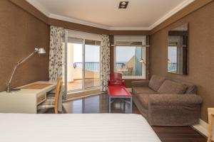 Кровать или кровати в номере Hotel Playa Victoria