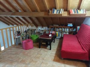 a living room with a red couch and a table at Casa da Celeste-AL in Areias