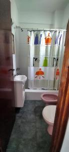 a bathroom with a pink toilet and a sink at Alfonsina y el Mar in Mar del Plata +6 photos