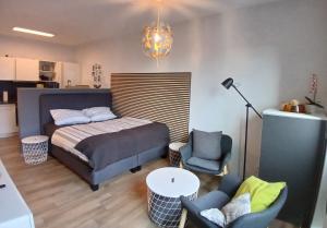 une chambre avec un lit, une table et des chaises dans l'établissement Ferienwohnung Port Marina 419, das Hafen-Apartment in perfekter Lage!, à Bremerhaven