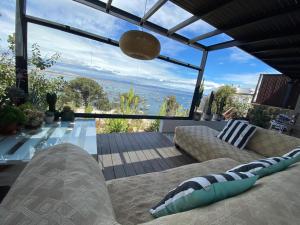 a living room with a view of the ocean at Preciosa casa frente al mar in Tongoy +18 photos