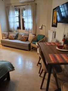 a living room with a couch and a table at Athina in Thessaloniki