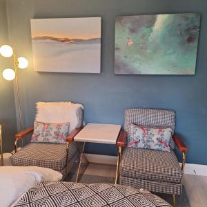 a room with two chairs and a table and a bed at No 12 B&B in Dungarvan