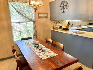 a kitchen with a wooden table in a kitchen at Rose's House in Lanett