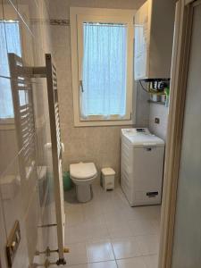a small bathroom with a toilet and a window at La Brentella in Arzergrande