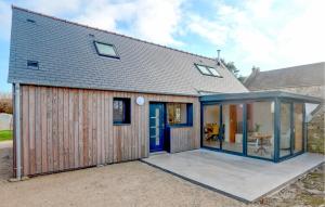an extension to a house with glass doors at Stunning Home In Flottemanville-Hague in Flottemanville-Hague +23 photos