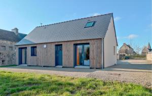 a house with wooden cladding on the side of it at Stunning Home In Flottemanville-Hague in Flottemanville-Hague