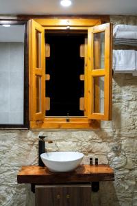 a bathroom with a sink and a window at Vouni Calais in Vouni