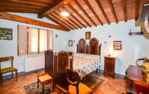 a bedroom with a bed and a chair and a table at Beautiful Home In Cortona With Wifi in Cortona