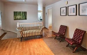 a living room with two chairs and a couch at 4 Bedroom Awesome Home In Sandefjord in Sandefjord