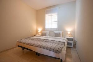 a bedroom with a large bed with a window at Espacioso apartamento en Mijas con parking privado in Sitio de Calahonda +29 photos