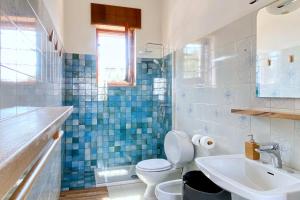 a bathroom with a toilet and a sink at Villa Elena - Seafront & Comfort by Salento Prime in Torre Vado +42 photos