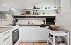 a white kitchen with white cabinets and a sink at Three-Bedroom Holiday Home In Thisted in Nørre Vorupør