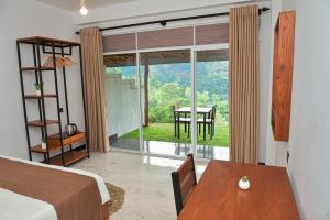 a bedroom with a bed and a table and a window at Tea Hills Ella in Ella