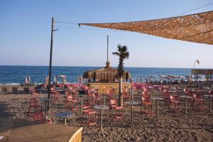 a bunch of chairs and tables on a beach at Wolf Suites in Antalya