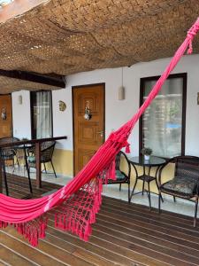 a hammock on the porch of a house at Pousada Aventurine Noronha in Fernando de Noronha +61 photos