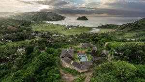 an aerial view of a house on a hill next to the ocean at Villa Ellya Areguling, for 8-10 Pax in Kuta Lombok