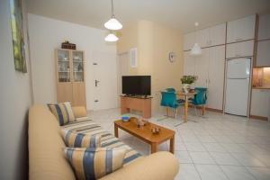 a living room with a couch and a table at Comfi apartment Kleio in Heraklio Town