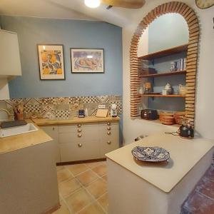 a kitchen with a sink and a counter top at La Biznaga - Comares in Comares