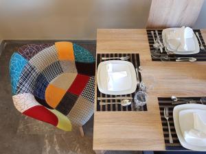 a table with a colorful table cloth on top at City Center Apartment Project by Cretan Houses in Heraklio
