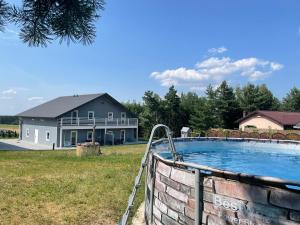 a swimming pool in front of a house at Sielsko-Anielsko Kobyla Góra I in Ligota
