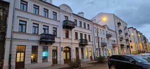 a row of white buildings on a city street at Koneser Warsaw by Better Place in Warsaw