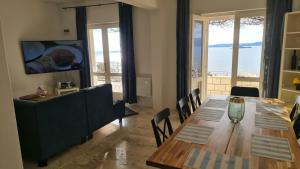 a dining room with a table and a couch at Villa More in Postup