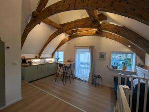 a kitchen with wooden beams and a table in a room at B&B TxL in De Cocksdorp