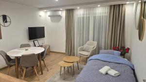 a hospital room with a bed and a table and chairs at Bella Vacanza Apartment in Banja Luka
